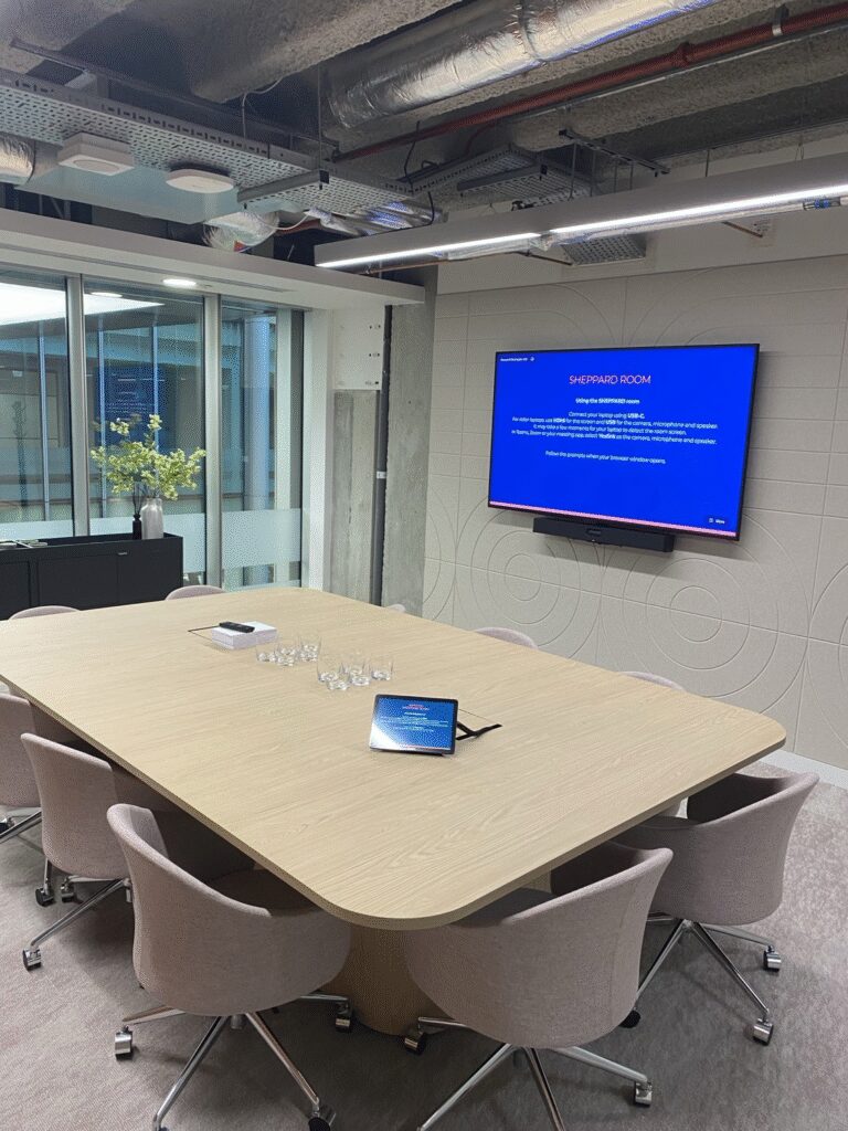 Meeting Room Table With Display and Video Conferencing Solution on the wall